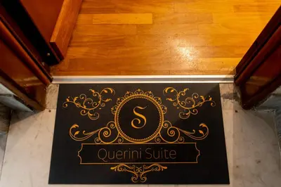 a sign for a quentin suite on a wooden floor at Querini Suite Roma in Rome