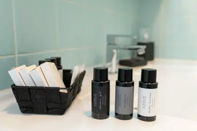 a group of three products sitting next to a basket of books at Querini Suite Roma in Rome