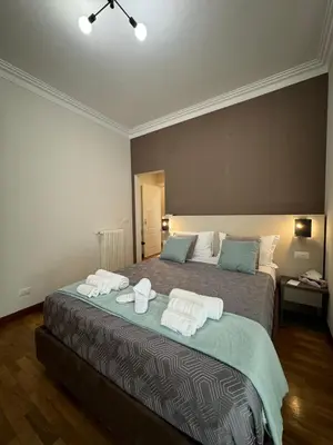 a bedroom with a bed with towels on it at Querini Suite Roma in Rome