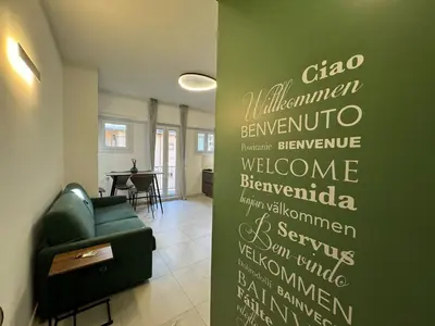 a living room with a green wall with writing on it at Numiro in Rome