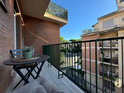 a balcony with a table and a fence at Numiro in Rome