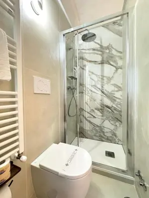 a bathroom with a shower and a white toilet at May Home Guest House in Rome