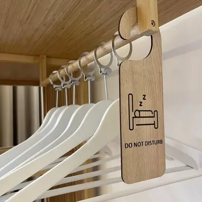 a wooden sign on a rack in a closet at May Home Guest House in Rome
