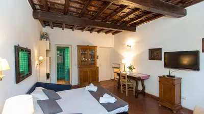 a bedroom with a bed and a table and a television at Scala Studio by Rental in Rome in Rome