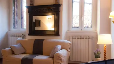 a living room with a couch and a mirror at Scala Studio by Rental in Rome in Rome
