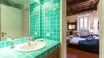 a bathroom with a sink and a bedroom at Scala Studio by Rental in Rome in Rome