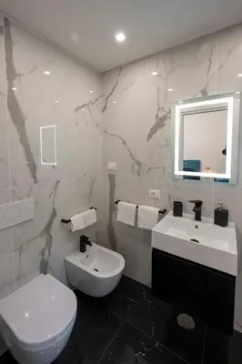 a bathroom with a white toilet and a sink at Jacuzzi Rooms Vatican Museum in Rome