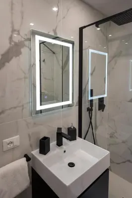 a bathroom with a white sink and a mirror at Jacuzzi Rooms Vatican Museum in Rome