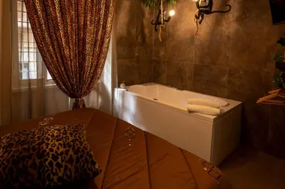 a bathroom with a bath tub in a room at Jacuzzi Rooms Vatican Museum in Rome