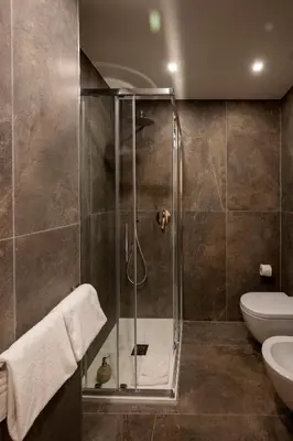 a bathroom with a shower and a toilet at Jacuzzi Rooms Vatican Museum in Rome