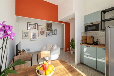 a kitchen and dining room with a bowl of fruit on a table at Kaizen The Barista 3BR Apartment With Coffee Station in Rome