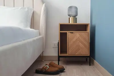 a bedroom with a bed and a night stand with shoes at Kaizen The Barista 3BR Apartment With Coffee Station in Rome