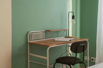 a desk and a chair in a room at Kaizen The Barista 3BR Apartment With Coffee Station in Rome