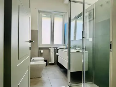 a bathroom with a toilet and a sink and a shower at The 7th Apartment in Rome