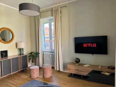 a living room with a flat screen tv on a wall at The 7th Apartment in Rome