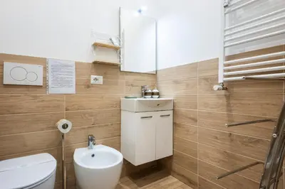 a bathroom with a sink and a toilet and a mirror at La CASA di EMY in Rome