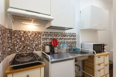 a small kitchen with a sink and a stove at La CASA di EMY in Rome