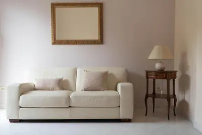 a living room with a white couch and a table at Tiziano apartment-a spacious home for you in Rome in Rome