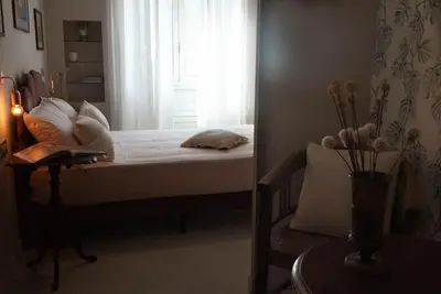 a bedroom with a bed with a window and a table at Tiziano apartment-a spacious home for you in Rome in Rome