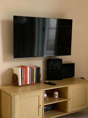 a television on top of a book shelf with books at Tiziano apartment-a spacious home for you in Rome in Rome