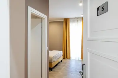 a bedroom with a bed and a door to a room at Colonna Inn in Rome