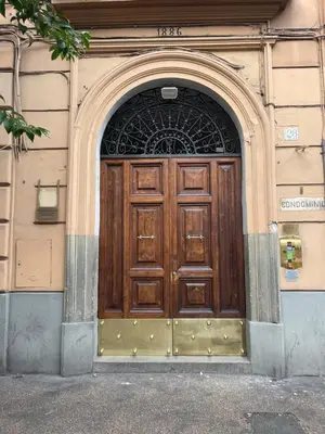 a large wooden door on a building at Colonna Inn in Rome