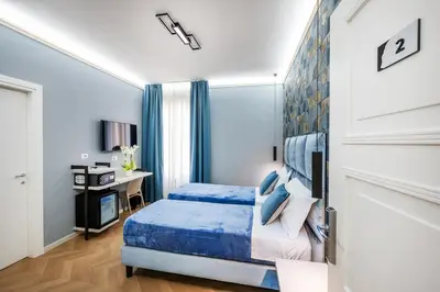 a bedroom with a bed and a desk at Colonna Inn in Rome