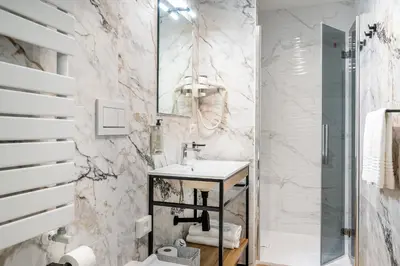a white bathroom with a sink and a shower at Colonna Inn in Rome