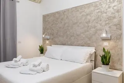 a glass vase filled with rocks and plants on a table at Gregorio VII Luxury Home Apartment in Rome