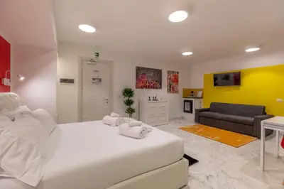 a bedroom with two beds and a television in it at Gregorio VII Luxury Home Apartment in Rome