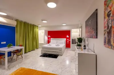 two beds in a room with white walls at Gregorio VII Luxury Home Apartment in Rome