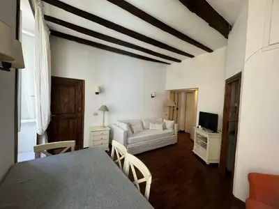 a living room with a table and a couch at Suite Colonna in Balestrari in Rome