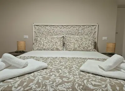 a bedroom with a large bed with two pillows on it at Al Fontanile in Rome