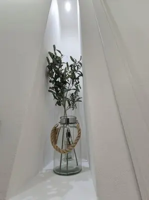 a vase with a plant in it on a shelf at Al Fontanile in Rome