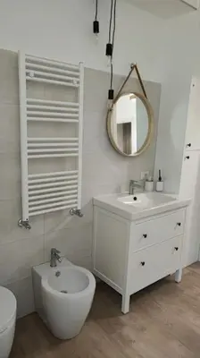 a bathroom with a sink and a toilet and a mirror at Al Fontanile in Rome