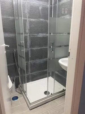 a shower with a glass door in a bathroom at Parenti B&B in Rome