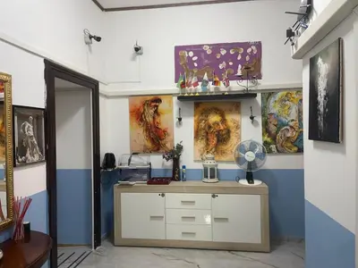 a room with a desk with paintings on the walls at Parenti B&B in Rome