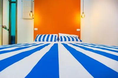 a blue and white bed in a room at ColoRHome in Rome