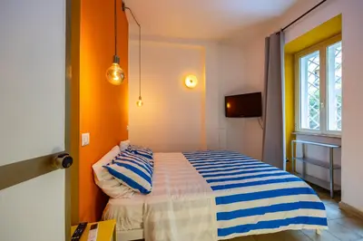 a bedroom with a bed with blue and white stripes at ColoRHome in Rome