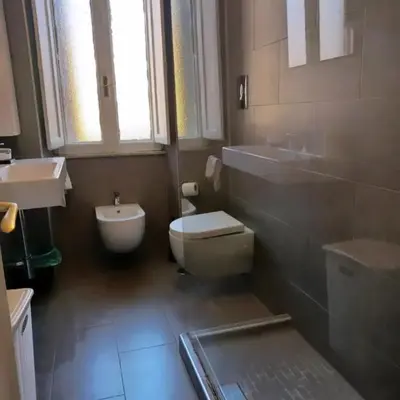 a bathroom with a white toilet and a sink at Rome Appartment in Rome