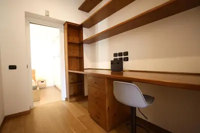 a home office with a desk and a white chair at Ponte Milvio Lovely Garden in Rome