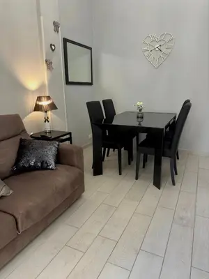 a living room with a couch and a table and chairs at La Casa di G Metro A tra Vaticano e Gemelli in Rome