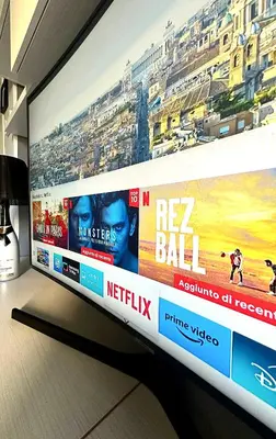 a large television screen with avertisement at La Casa di G Metro A tra Vaticano e Gemelli in Rome