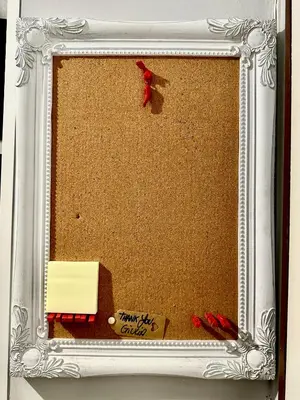 a picture frame with a card and a red ribbon at La Casa di G Metro A tra Vaticano e Gemelli in Rome