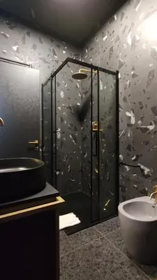 a bathroom with a shower with a sink and a toilet at Auri Vatican apartment in Rome