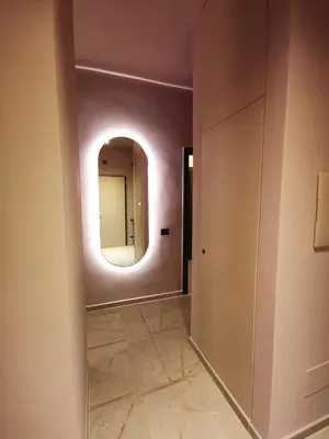 a hallway with a mirror on the wall at Auri Vatican apartment in Rome