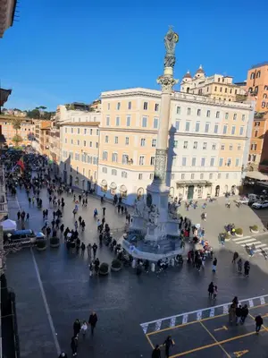 a crowd of people standing around a statue in a plaza at Piazza di Spagna 51 Luxury guest house in Rome