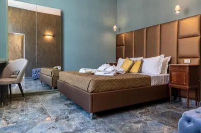 a bedroom with a large bed with a large headboard at Piazza di Spagna 51 Luxury guest house in Rome