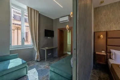 a hotel room with a bed and a tv at Piazza di Spagna 51 Luxury guest house in Rome