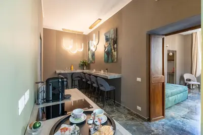 a room with a kitchen and a living room at Piazza di Spagna 51 Luxury guest house in Rome